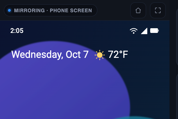 The phone screen mirrored on the Tesla display, with Home and fullscreen buttons